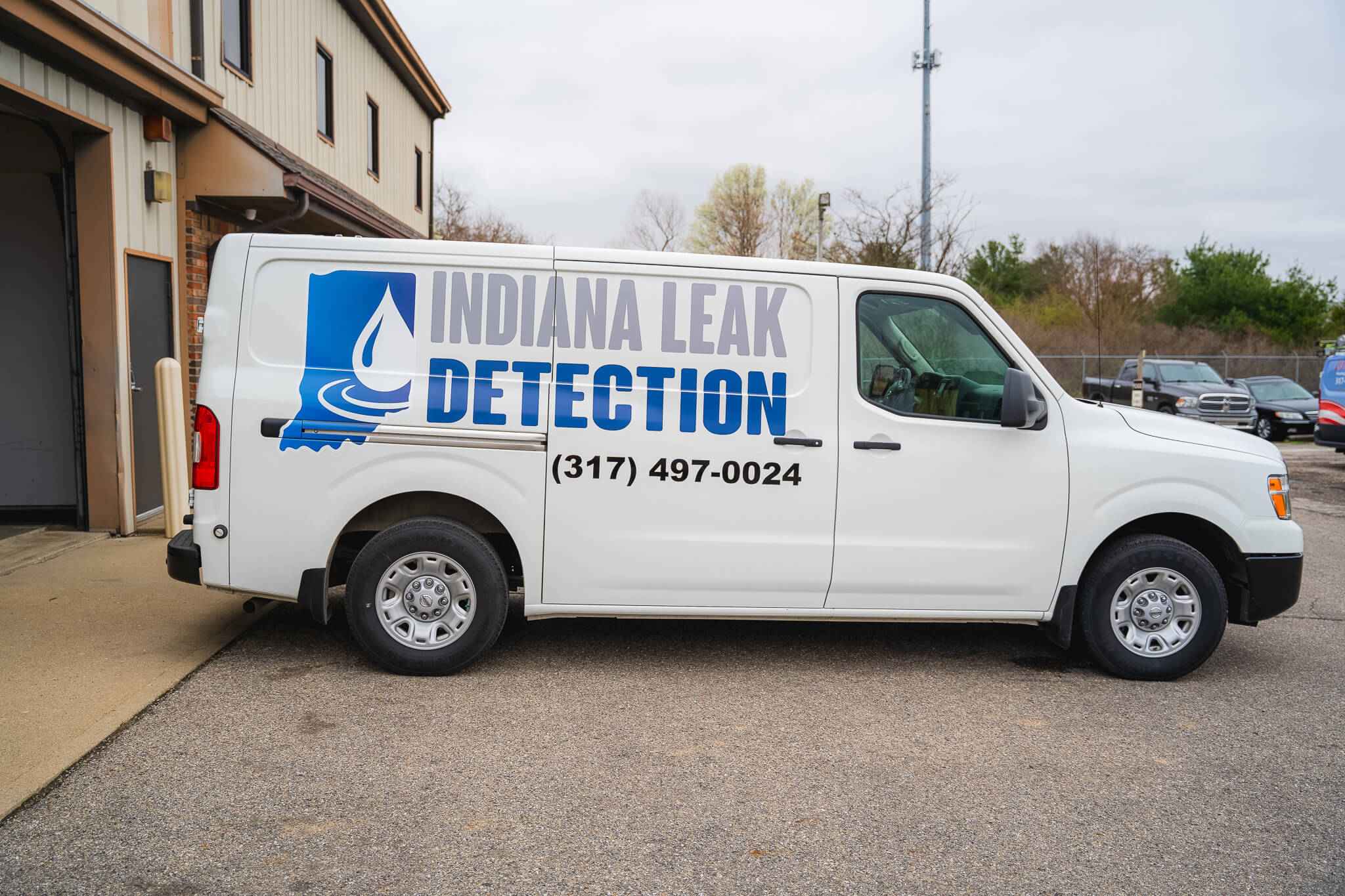 Photo of some Indiana Leak Detection technicians standing proudly with a van